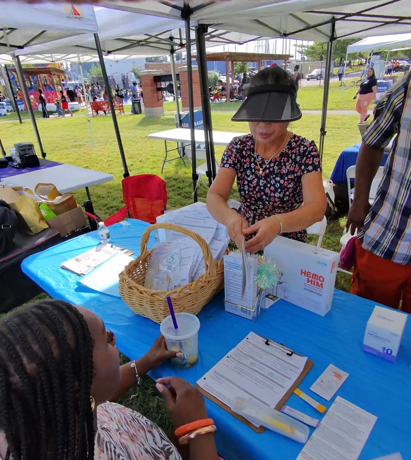 Kyong Jimerson educating a community member at the STLHospital-Free Future booth
